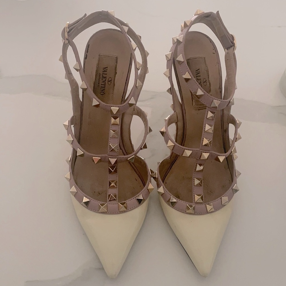 Valentino Garavani Ivory Rockstud Ankle Strap Pump With Gold Studs.